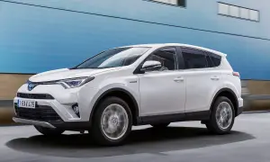 Vit Toyota RAV4 Hybrid körs på vägen, kanske med ett **toyota rav4 automat problem** som behöver åtgärdas.