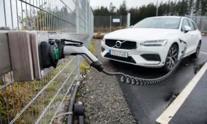 En vit Volvo laddas vid en laddstation. Perfekt för att hitta laddstationer när du är på språng.